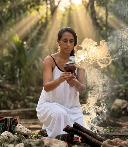 Mila preparing sacred smoke for an ayahuasca ceremony serving Cancun guests